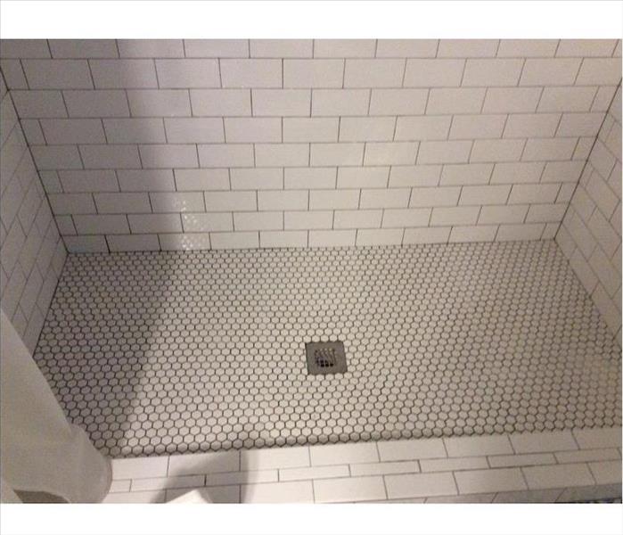 Clean white tiled shower