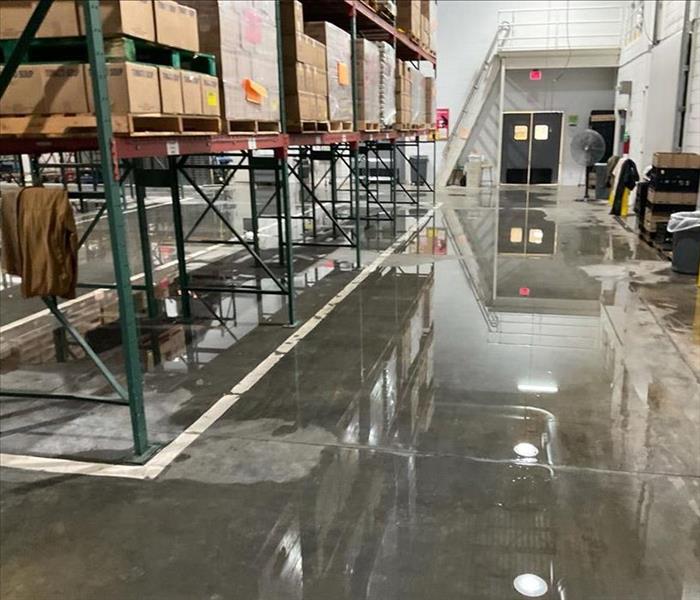 Warehouse with standing water by storage racks