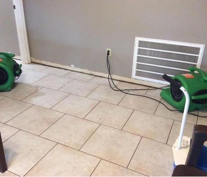 SERVPRO air movers on tile floor by vent