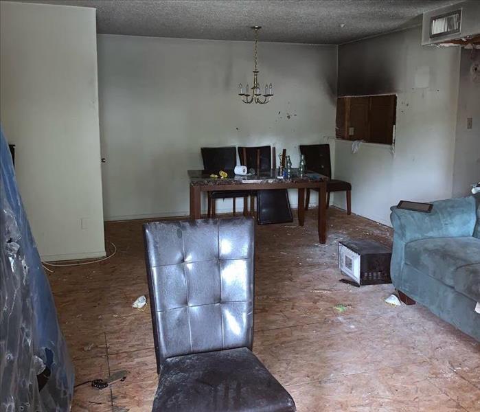 Room with commercial fire damage with chair and sofa