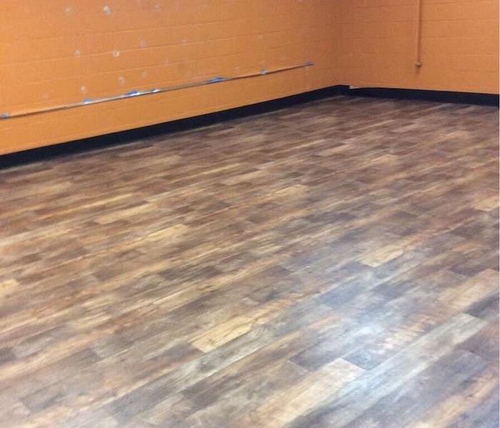 Gym with laminate flooring and cinder block wall