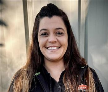 Amber Farria, Restoration Supervisor, in a black SERVPRO HEROReady shirt standing in front of a white background