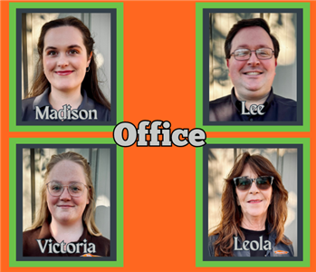 Four office team members in various SERVPRO attire standing in front of a white background.