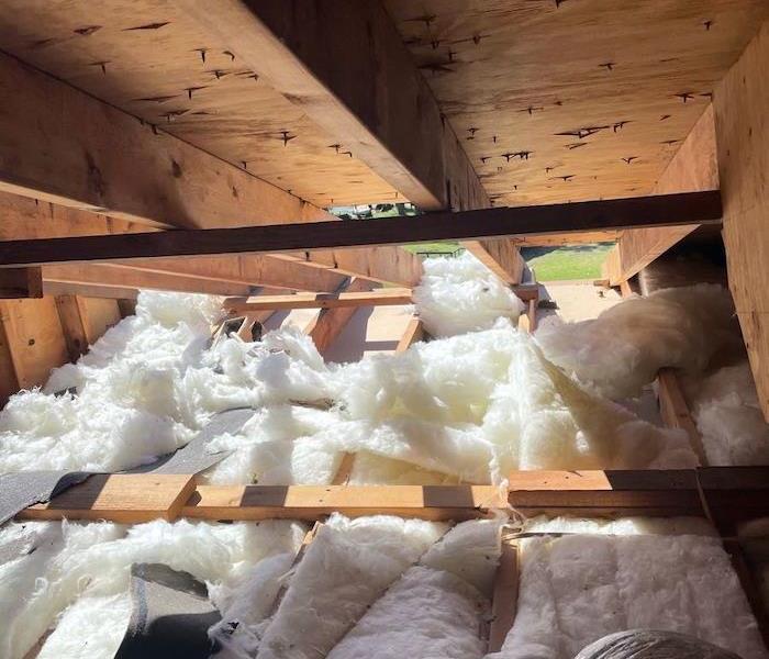 Attic with insulation and exposed hole in the roof