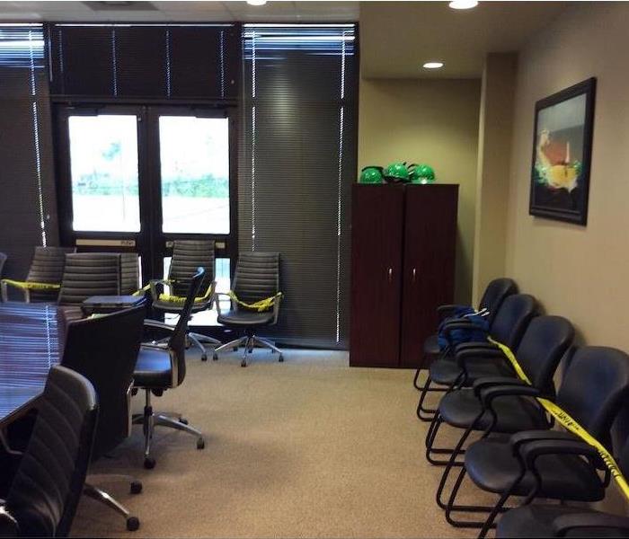 Office chairs and desks with yellow hazard tape