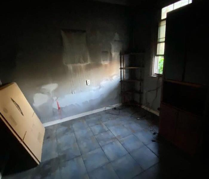Room with smoke damaged walls and tile floor
