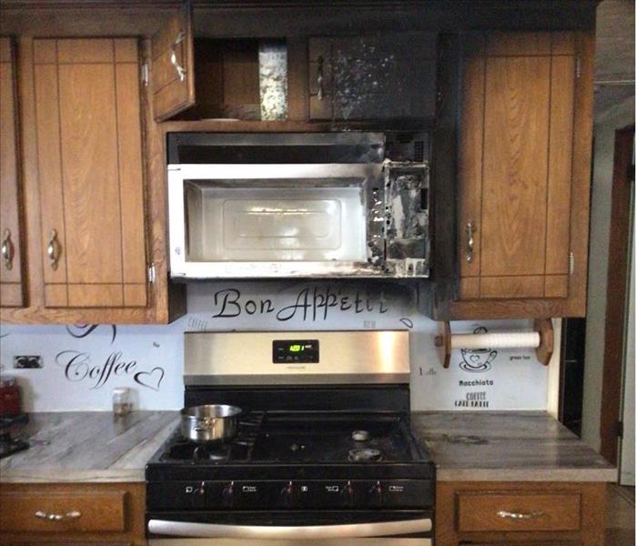 charred kitchen range and microwave