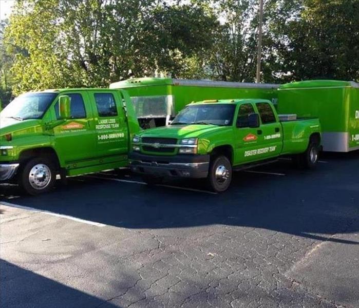 SERVPRO trucks parked in a driveway with equipment in their trailers