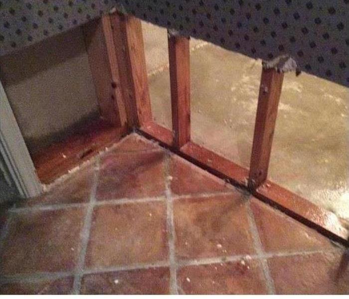 Flood Cut on lower wall by red ceramic tile floor